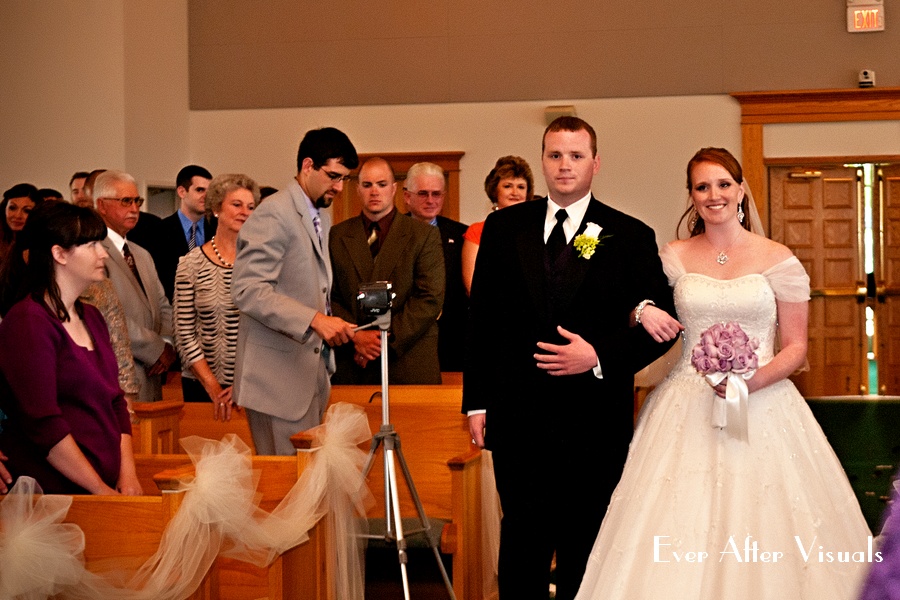 bride being escorted by brother down aisle