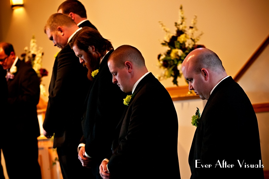 groomsmen praying during ceremony