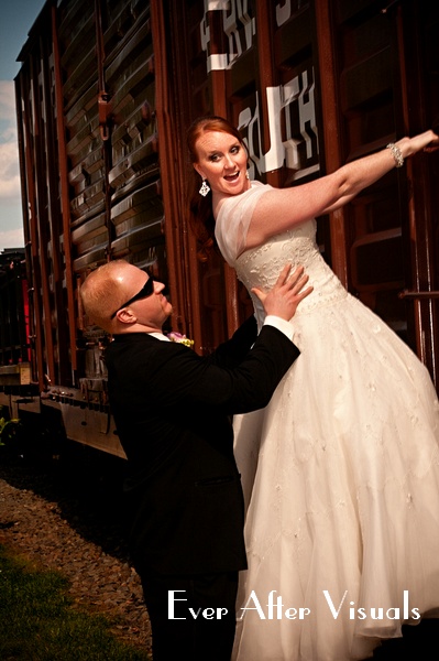 bride and groom having fun on a train