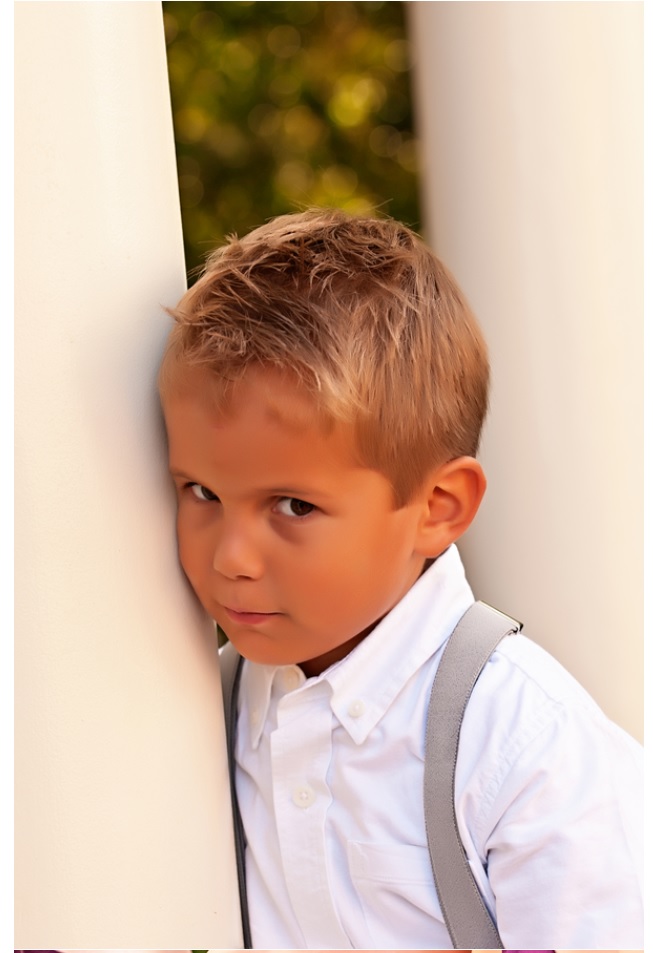 Little boy in white shirt with suspenders