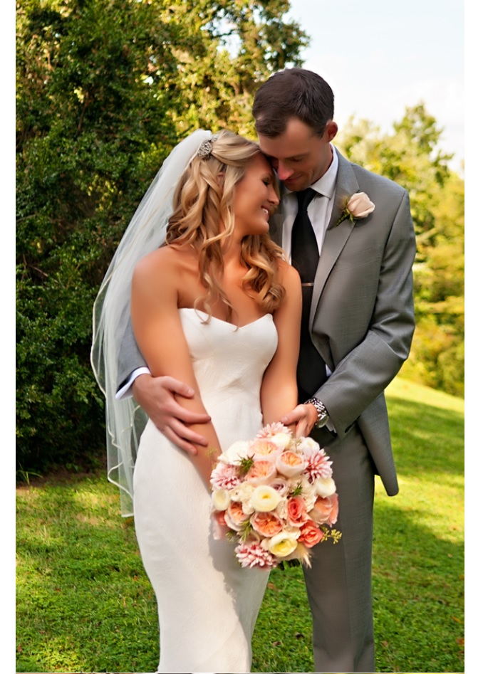 Bride and groom embrace in closeup portrait outdoors