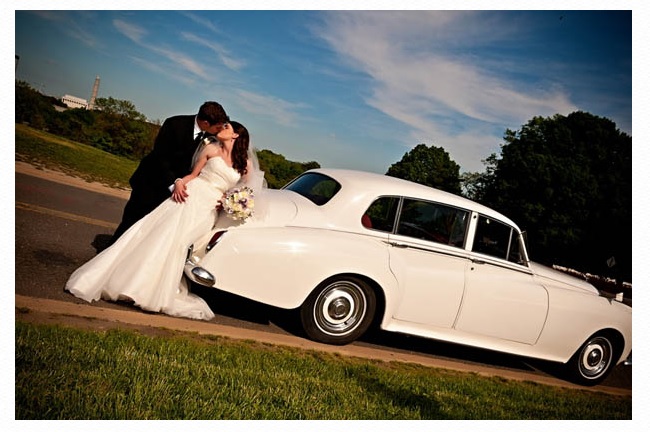 Bride and groom with white limousine.